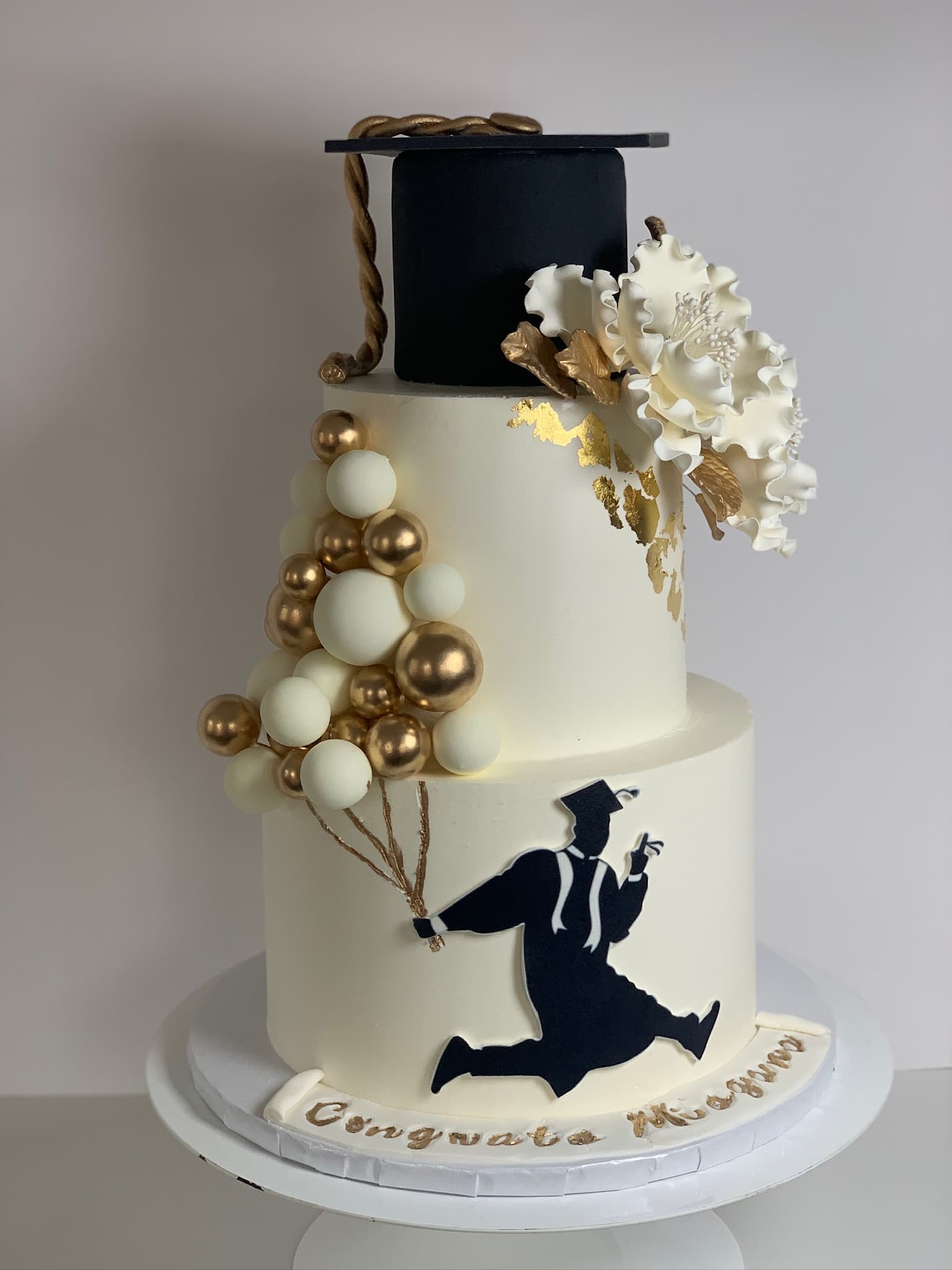 Black and gold silhouette cake — side view