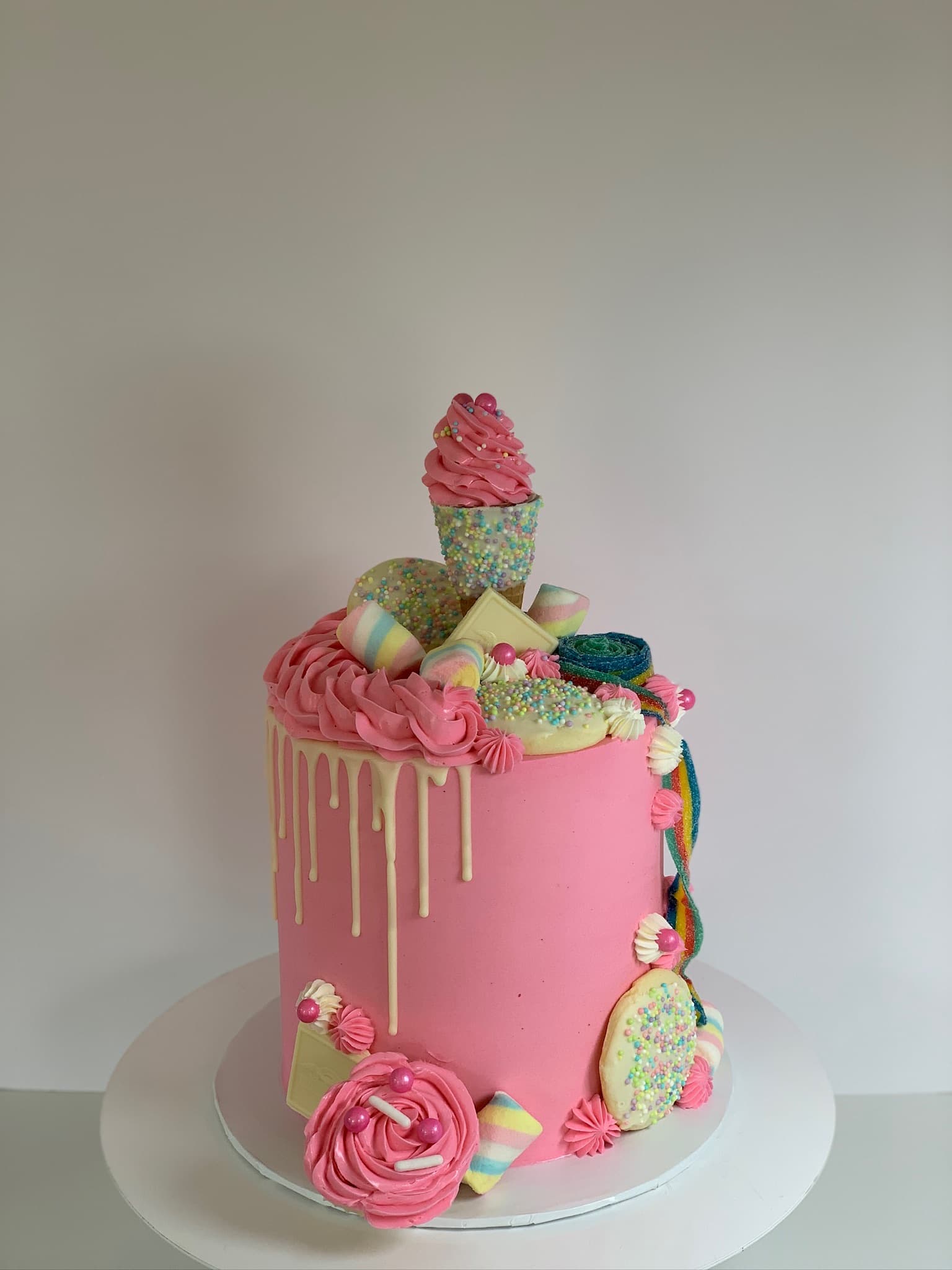 Pink candy drip birthday cake
